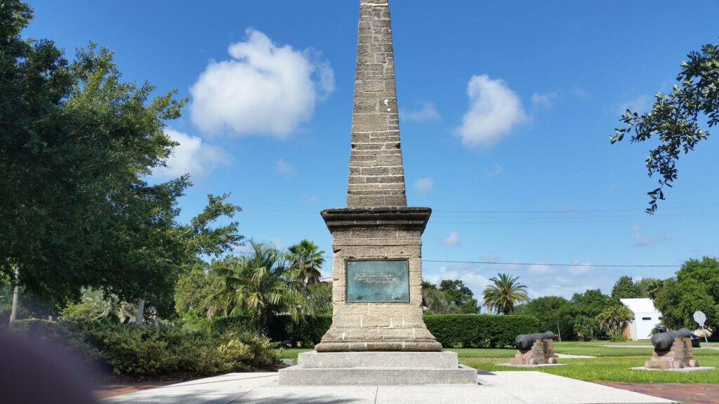 The coquina obelisk at Oglethorpe Battery Park against a blue sky